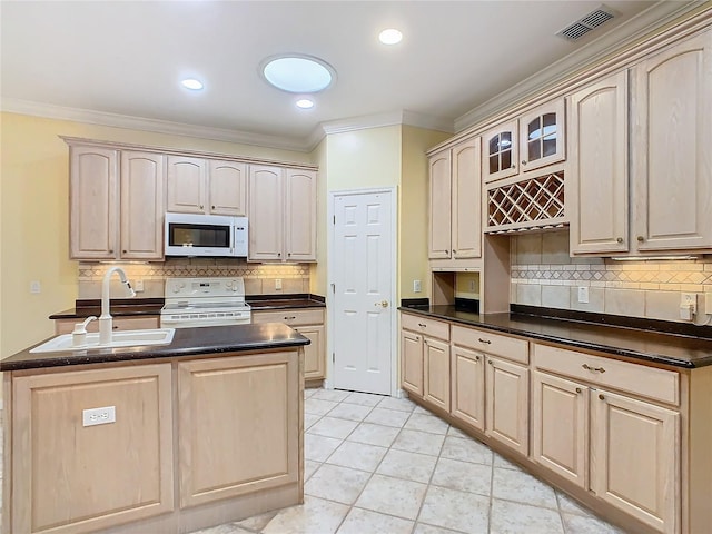 kitchen with glass insert cabinets, dark countertops, white appliances, and visible vents