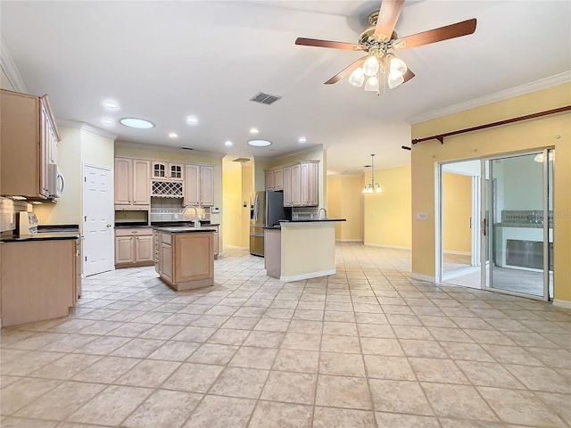 kitchen featuring a center island, stainless steel refrigerator with ice dispenser, dark countertops, visible vents, and hanging light fixtures