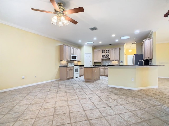 kitchen with crown molding, tasteful backsplash, dark countertops, a sink, and white appliances