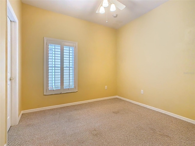 empty room featuring carpet floors, baseboards, and a ceiling fan