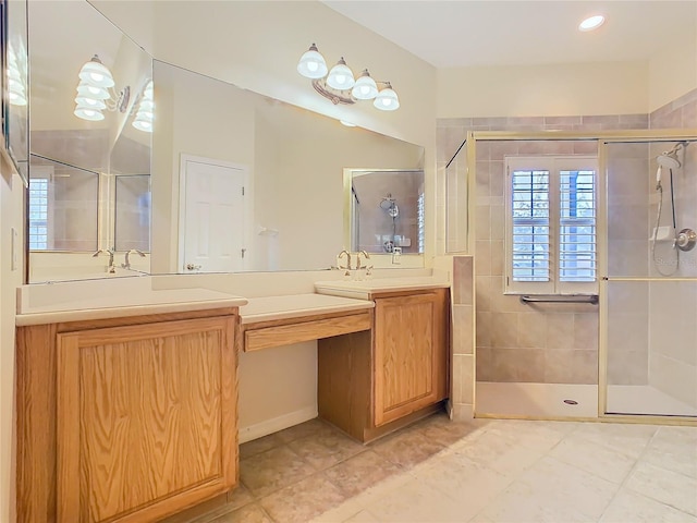 full bath with a stall shower, tile patterned flooring, and vanity