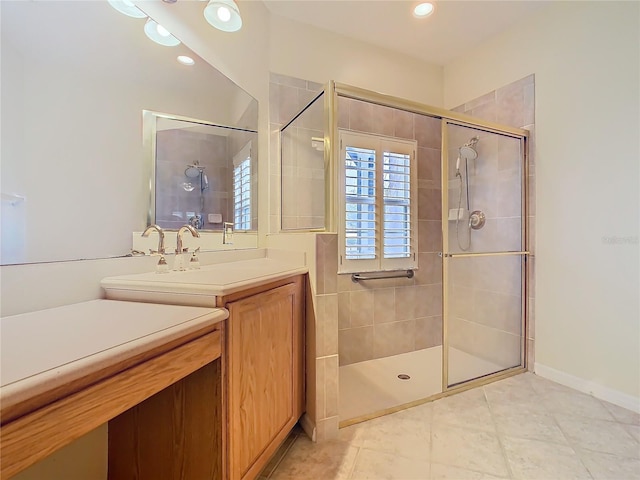 bathroom with a shower stall and vanity