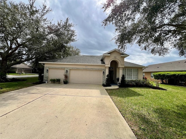 view of front of house with a front yard, driveway, an attached garage, and stucco siding