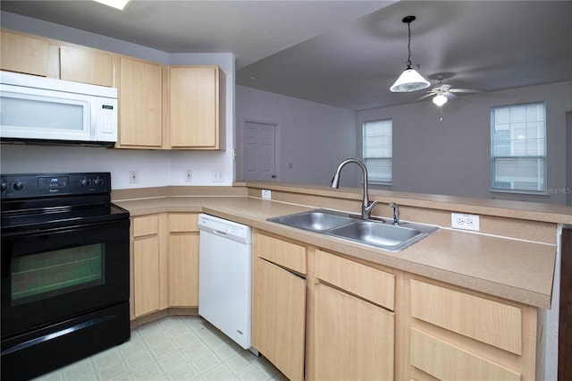 kitchen with a sink, light countertops, white appliances, and light brown cabinets