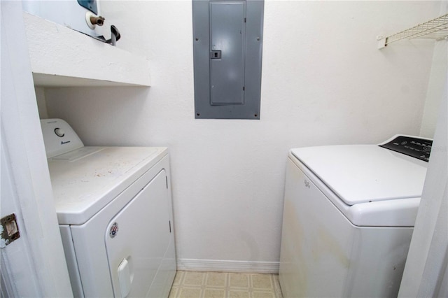 washroom featuring laundry area, electric panel, baseboards, independent washer and dryer, and light floors