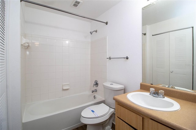 bathroom featuring toilet, visible vents, a closet, and vanity