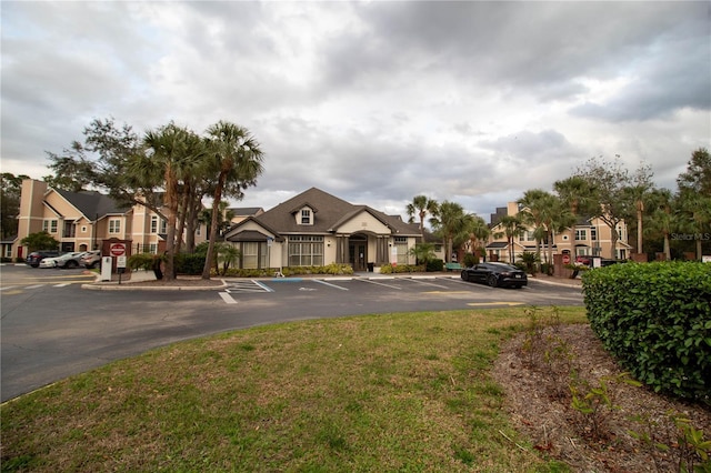 exterior space with traffic signs, a residential view, and curbs