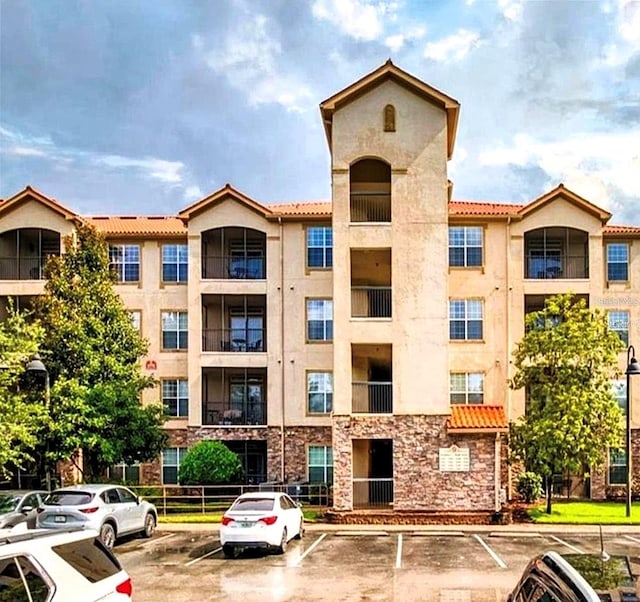 view of property featuring uncovered parking