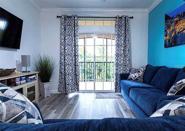 living area with wood finished floors and crown molding