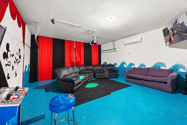 cinema room with a wall mounted air conditioner and a textured ceiling