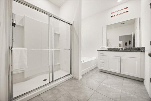 bathroom featuring tile patterned floors, vanity, and shower with separate bathtub