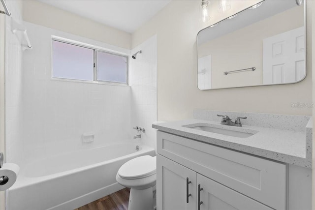 bathroom with vanity, shower / tub combination, toilet, and wood finished floors