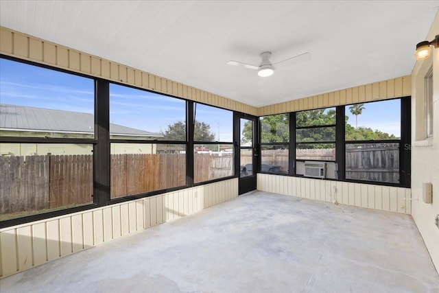 unfurnished sunroom featuring cooling unit and ceiling fan