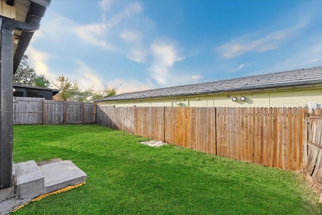 view of yard with a fenced backyard