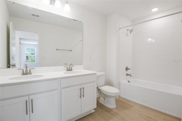 full bath featuring bathtub / shower combination, wood finish floors, a sink, and visible vents