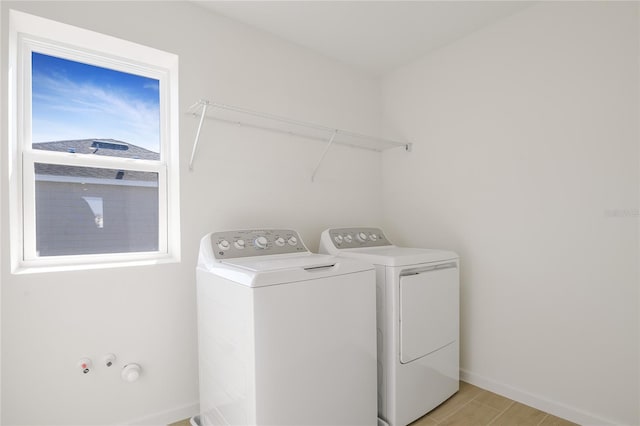 laundry room featuring laundry area, washing machine and dryer, and baseboards