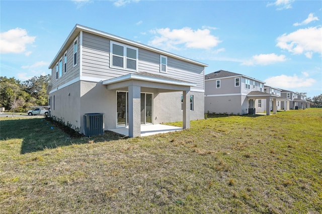 back of house with a patio, a lawn, cooling unit, and stucco siding