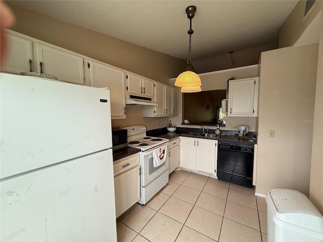 kitchen with dark countertops, white appliances, hanging light fixtures, and under cabinet range hood