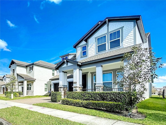 craftsman inspired home with covered porch and a front lawn