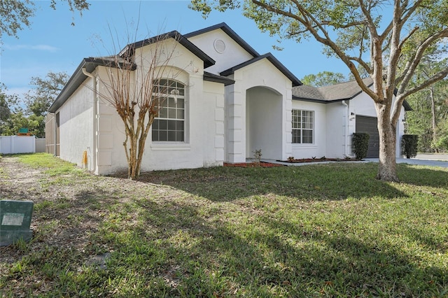 view of front facade with a front yard and a garage