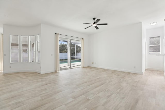 empty room with light hardwood / wood-style flooring and ceiling fan