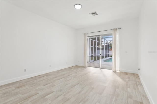 spare room with light hardwood / wood-style flooring