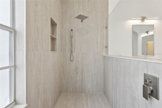 bathroom with plenty of natural light and a tile shower