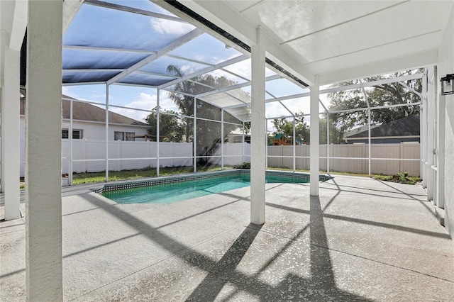 view of pool featuring glass enclosure and a patio area