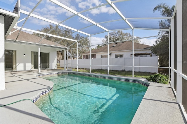 view of swimming pool with a patio area and glass enclosure