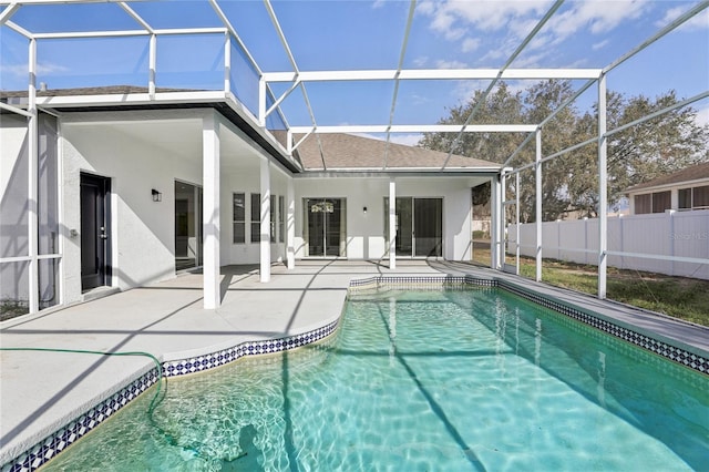 view of pool with glass enclosure and a patio area