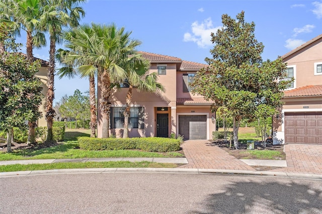 mediterranean / spanish-style house with a garage