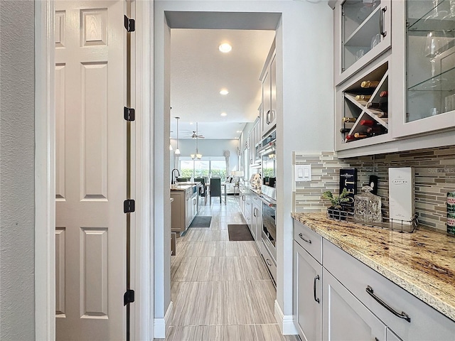 bar featuring recessed lighting, a sink, and backsplash