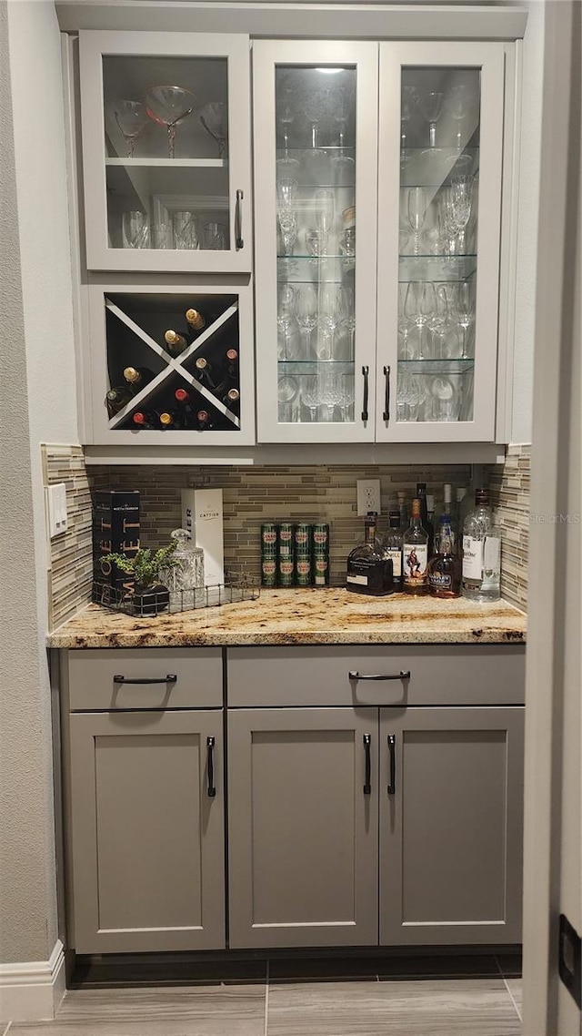 bar featuring a bar and decorative backsplash