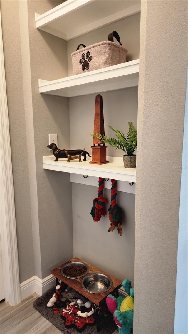 mudroom featuring wood finished floors and baseboards