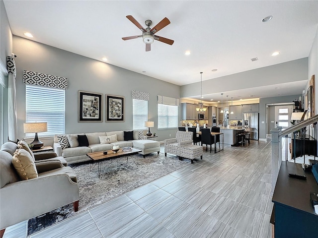 living area featuring a healthy amount of sunlight, visible vents, a ceiling fan, and recessed lighting