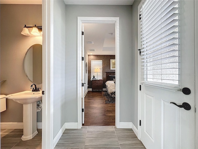 interior space featuring wood finished floors, visible vents, and baseboards