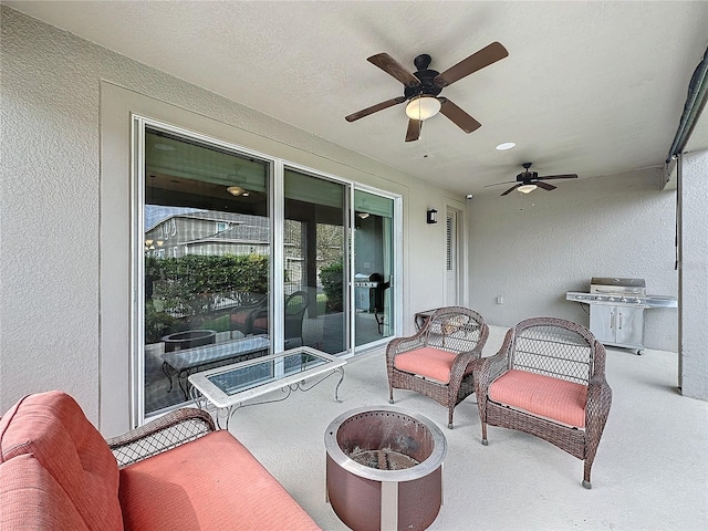 view of patio / terrace with ceiling fan, an outdoor fire pit, and a grill