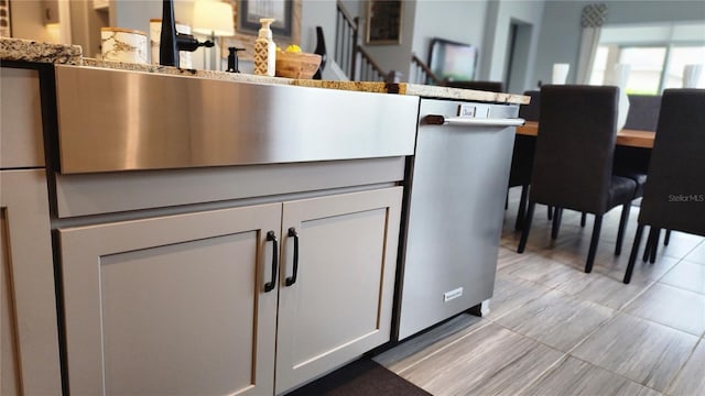 kitchen with white cabinetry and stainless steel dishwasher