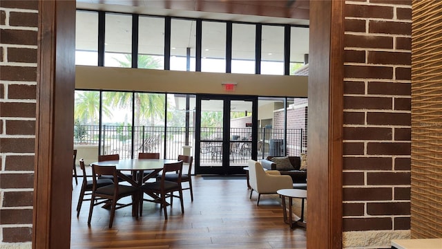 dining area featuring a high ceiling, dark wood finished floors, and french doors