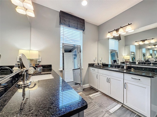 full bath featuring two vanities and a sink