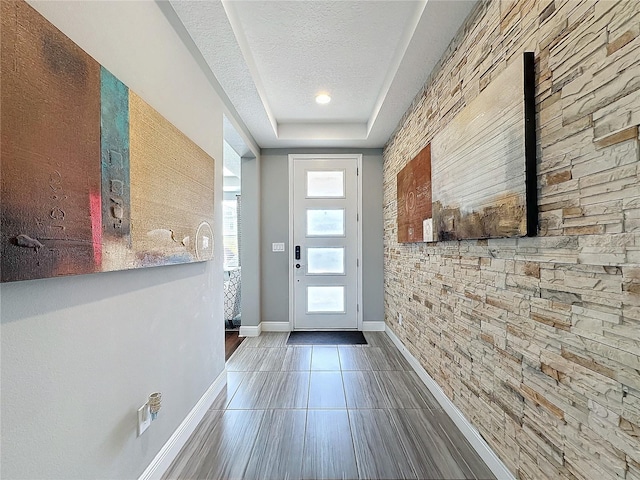 16150 Parkwyn St, Winter Garden, FL 34787 - entryway featuring tile patterned flooring, baseboards, and a textured ceiling