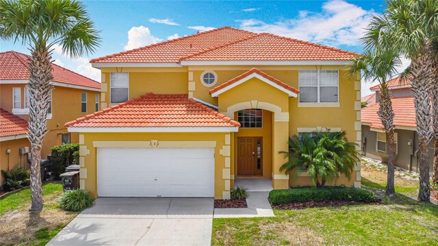 131 Stella Pass, Davenport, FL 33837 - mediterranean / spanish house featuring stucco siding, a tiled roof, driveway, an attached garage, and a front yard