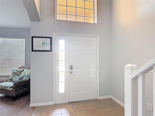 131 Stella Pass, Davenport, FL 33837 - entrance foyer with light tile patterned floors, plenty of natural light, and baseboards