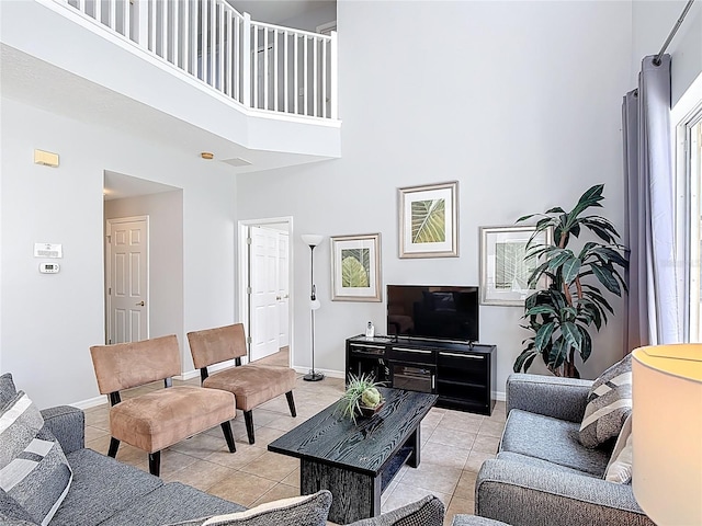 131 Stella Pass, Davenport, FL 33837 - living area featuring a high ceiling, light tile patterned floors, and baseboards