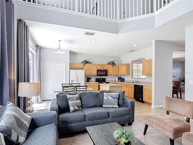 131 Stella Pass, Davenport, FL 33837 - living area featuring arched walkways and light tile patterned flooring