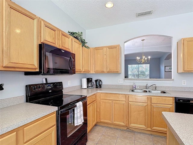 131 Stella Pass, Davenport, FL 33837 - kitchen with black appliances, a sink, light brown cabinetry, light countertops, and a textured ceiling