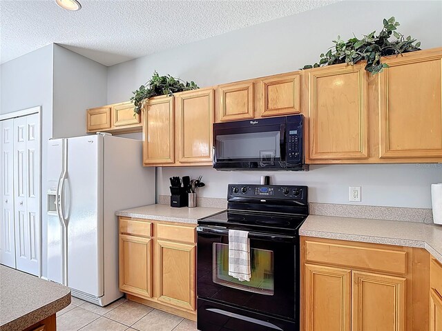 131 Stella Pass, Davenport, FL 33837 - kitchen with black appliances, a textured ceiling, light countertops, light tile patterned floors, and light brown cabinetry