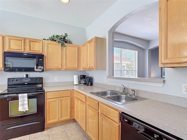131 Stella Pass, Davenport, FL 33837 - kitchen featuring black appliances, arched walkways, light brown cabinets, a sink, and a textured ceiling