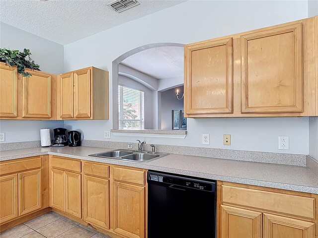 131 Stella Pass, Davenport, FL 33837 - kitchen with black dishwasher, a sink, light brown cabinetry, light countertops, and arched walkways