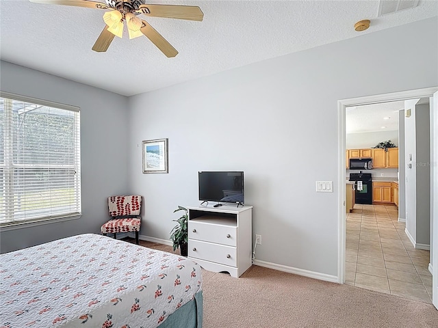 131 Stella Pass, Davenport, FL 33837 - bedroom with baseboards, a textured ceiling, light tile patterned floors, light colored carpet, and ceiling fan